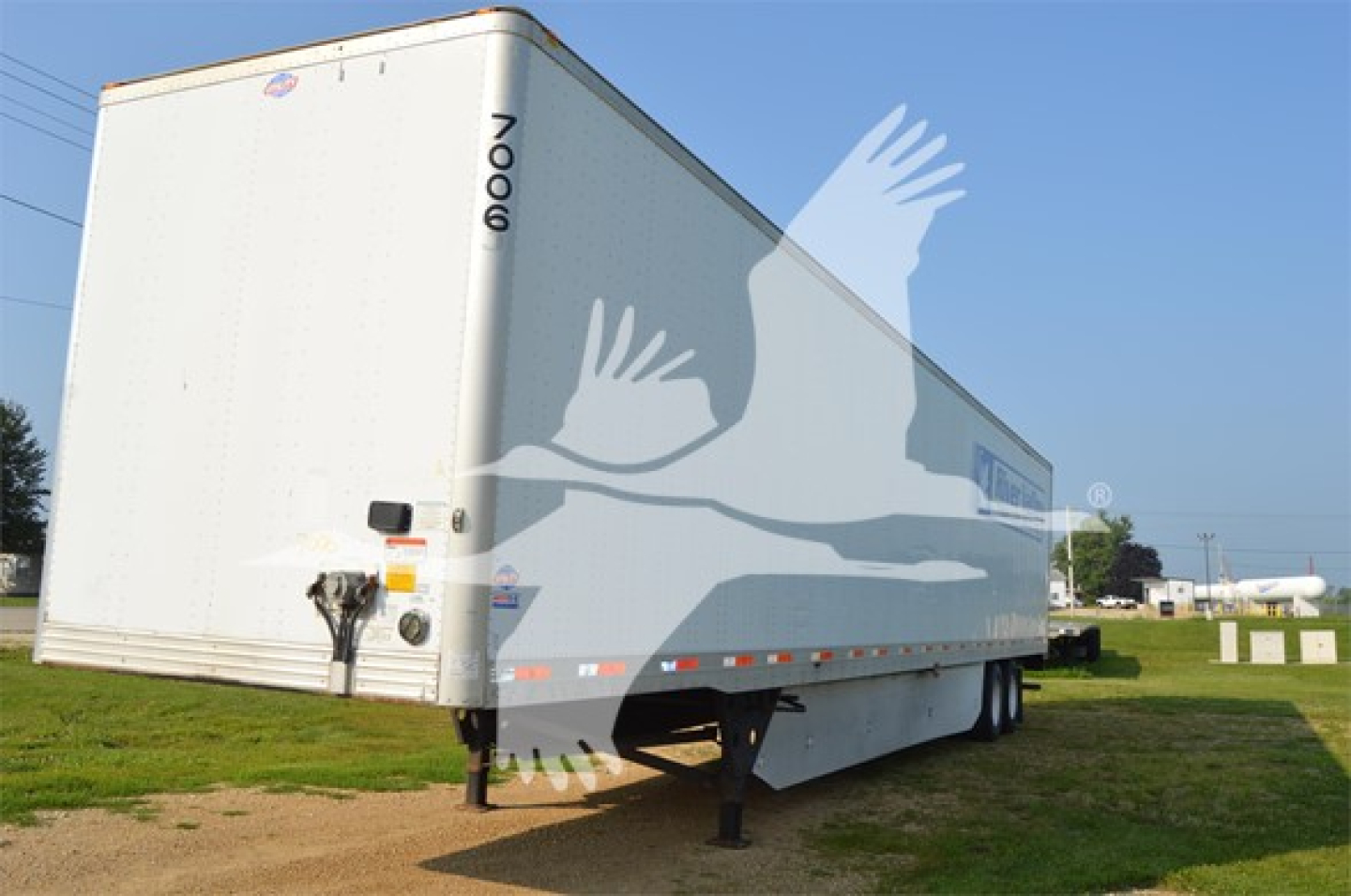 Trailer side view showing Utility 4000Dx with VIN 1UYVS2536H3946212 and stock number 7006-2.