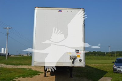 Utility 4000Dx trailer rear view with hitch and wheel supports visible.