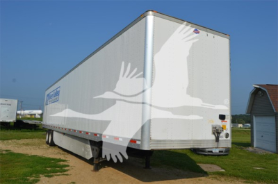 Trailer side view showing utility 4000Dx box trailer with white graphics and landing gear.