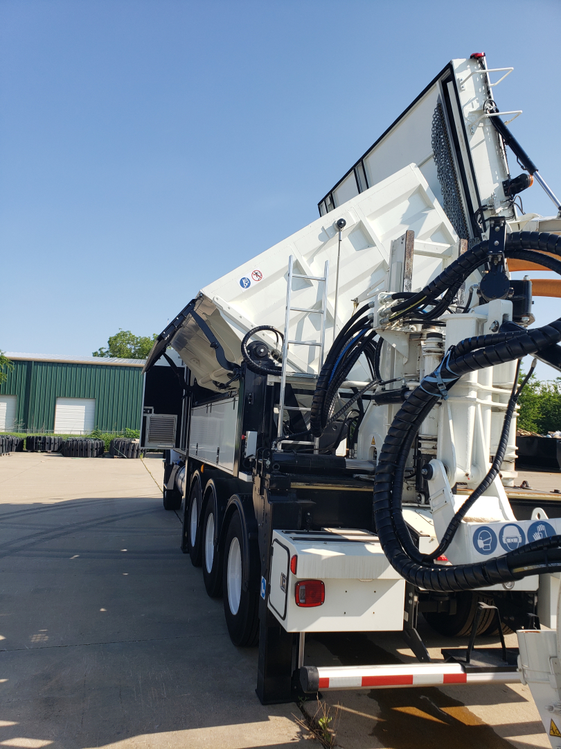 Volvo VHD86B300 truck with large trenching attachment mounted at rear, multiple axles, hydraulic hoses and control panels visible.