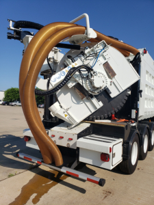 Volvo VHD86B300 truck component with large hose and machinery mounted in rear view showing equipment and hoses