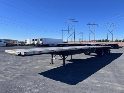 Utility flatbed trailer 2024 Utility 4000Ae with long low deck in an open lot, dual rear axles, and support legs visible.