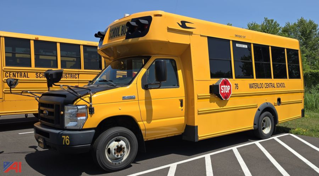 2018 Ford EC4 Micro Bird wheelchair bus showing yellow school bus with stop sign and 'WATERLOO CENTRAL SCHO' lettering on side; black front grille; '76' fleet number on bumper; wheel chair lift area not extended.