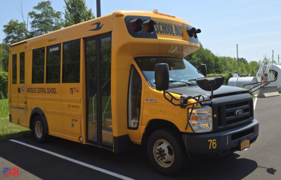 2018 Ford EC4 micro bus with wheelchair lift showing side view, yellow school bus with 'Medford Central School' text and number 76.