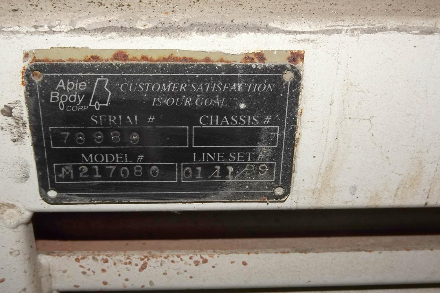 Identification plate on 1999 Ottawa 30 showing serial number 78989, model M217080, line set 01/12/99, chassis blank, customer satisfaction tag.