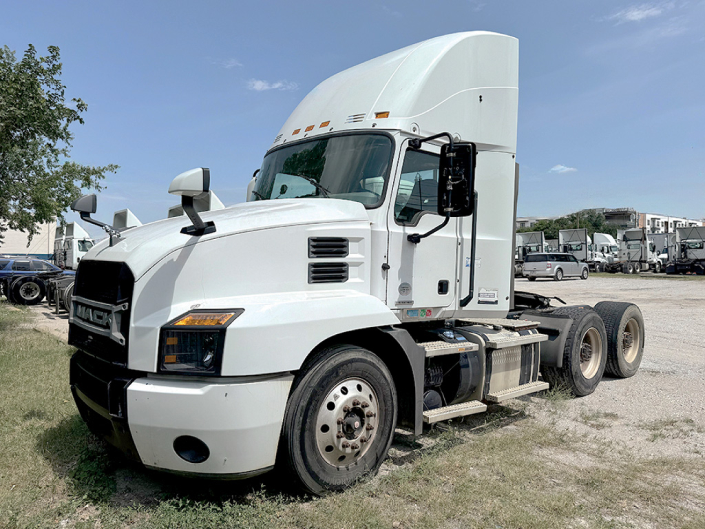 Mack Anthem truck in-yard showing front-left view with white cab and sleeper, dual rear axles, VIN and stock not visible in image