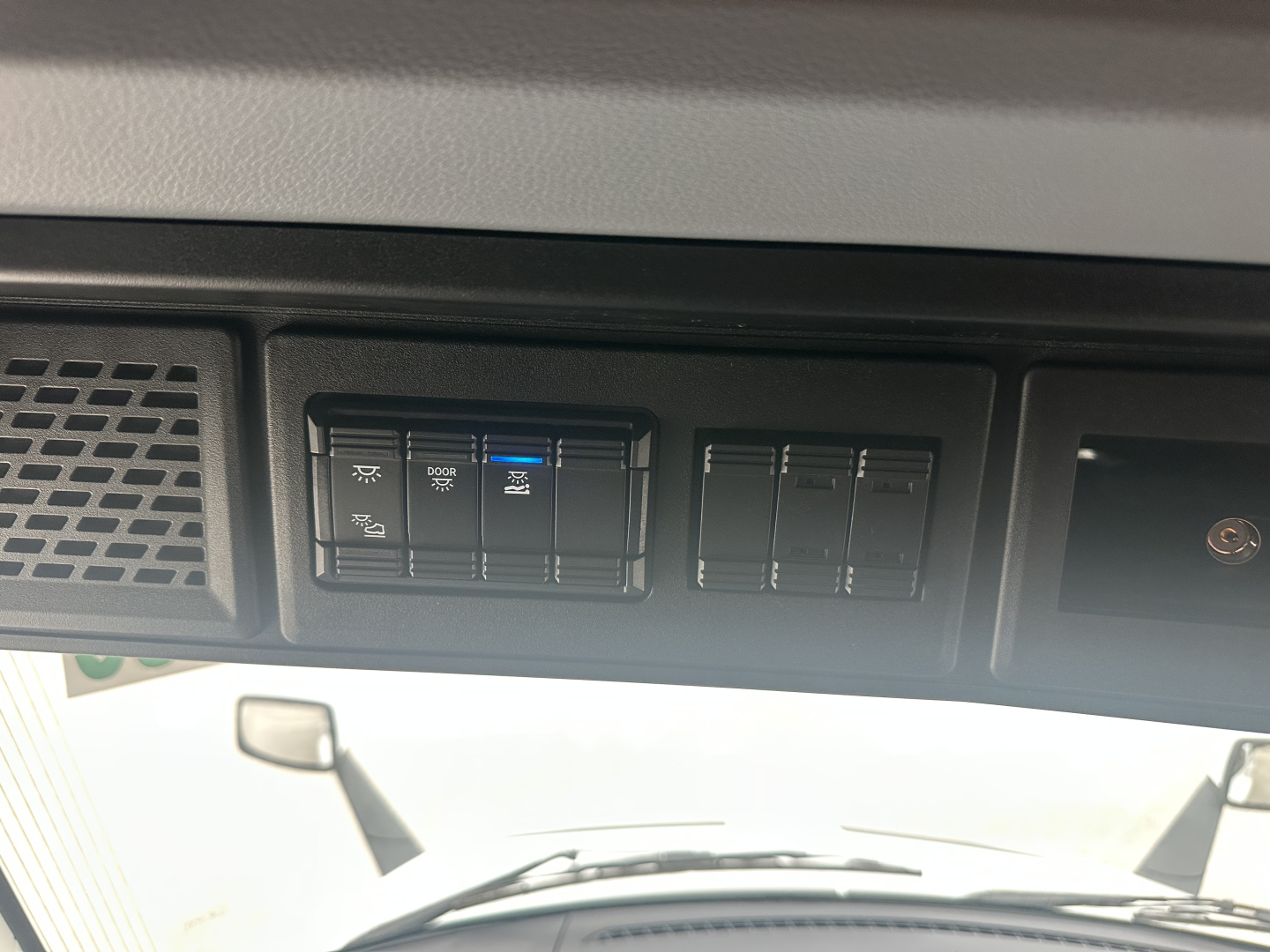 Truck dash panel showing switches and blank slots; no readable model text.