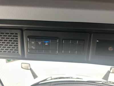 Truck dash panel showing switches and blank slots; no readable model text.