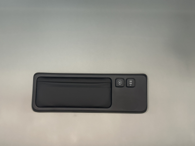 Cab interior window switch panel with two buttons on a metallic surface