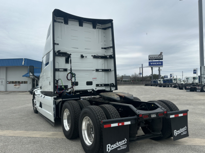 Truck cab rear view showing sleeper cab and chassis, with no visible text on the trailer side; rear mud flaps with Bruckner's logos.