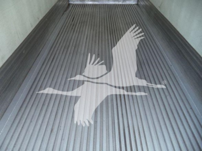 In-truck cargo bed of a refrigerated 2015 Hino 268A showing a white crane logo on a ribbed metal floor.