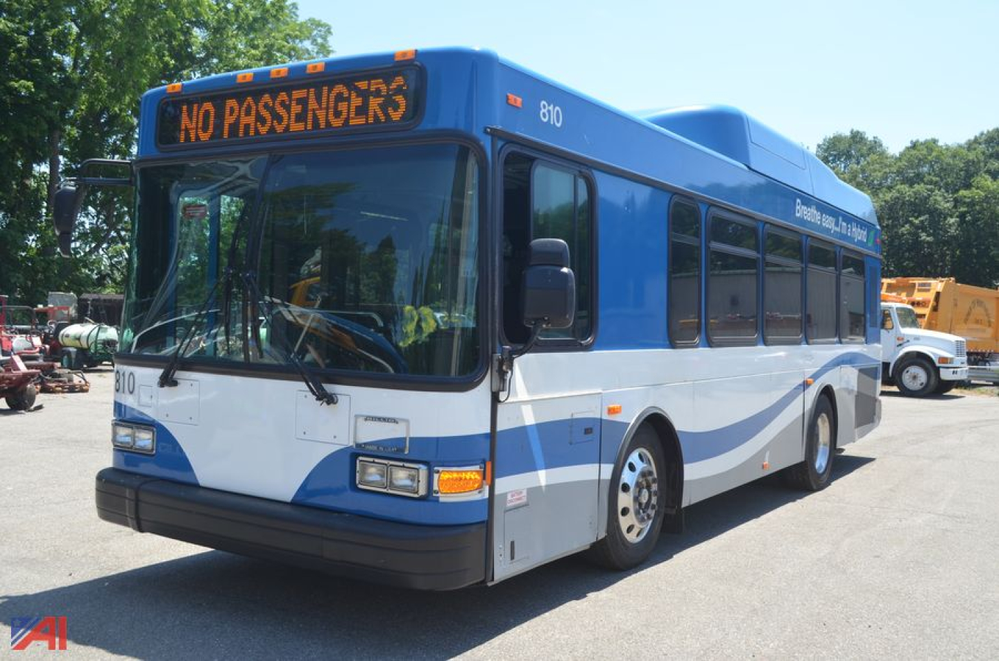 Bus showing No Passengers sign on windshield, blue and white Gillig Low Floor bus, front-left angle, exterior view