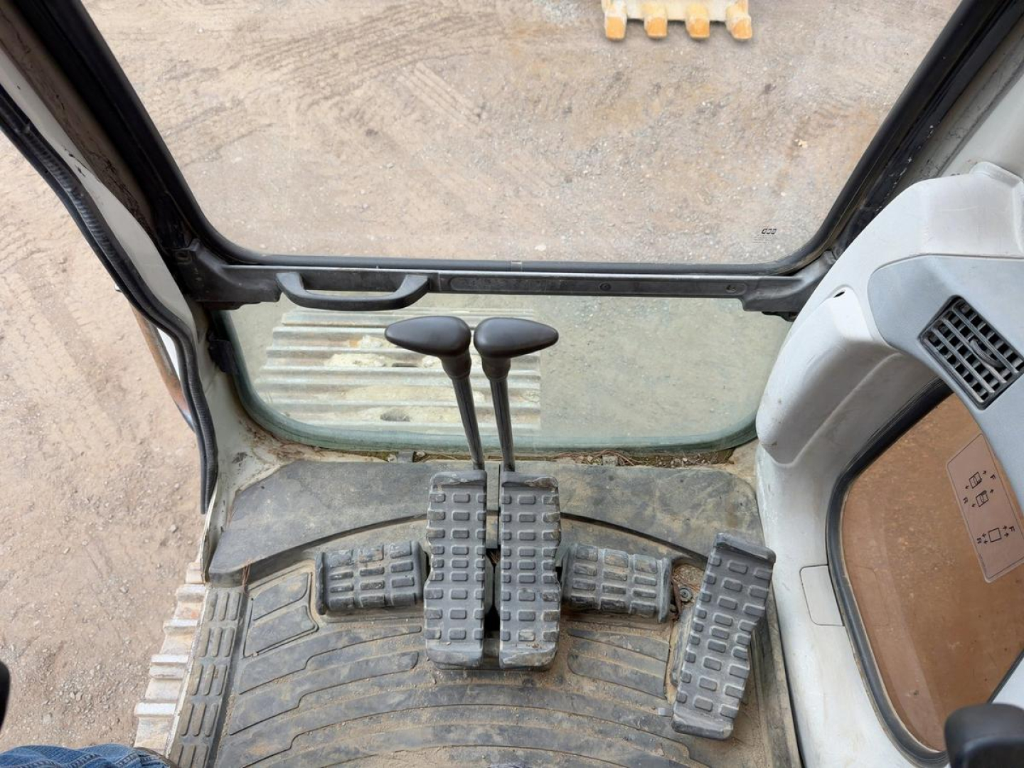 Excavator cab interior showing pedal controls and floor mat from a Link Belt 330LX.
