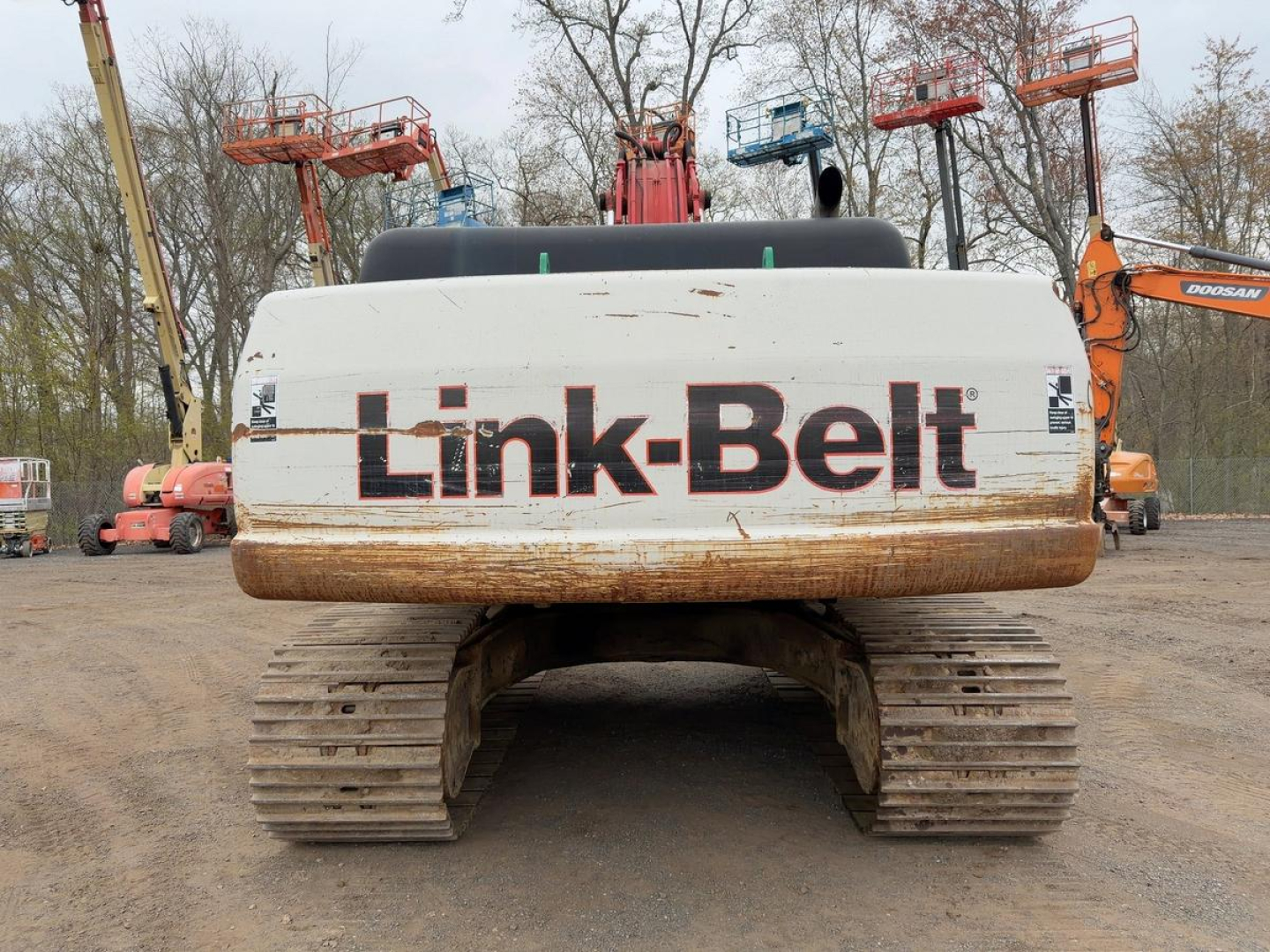 Link-Belt 330LX excavator belly view showing rear engine cover and tracked undercarriage.