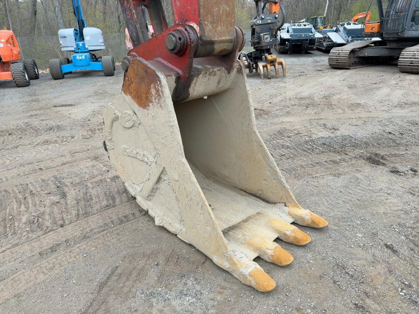 Buckets of a Link Belt 330LX excavator with yellow tips on the bucket teeth.