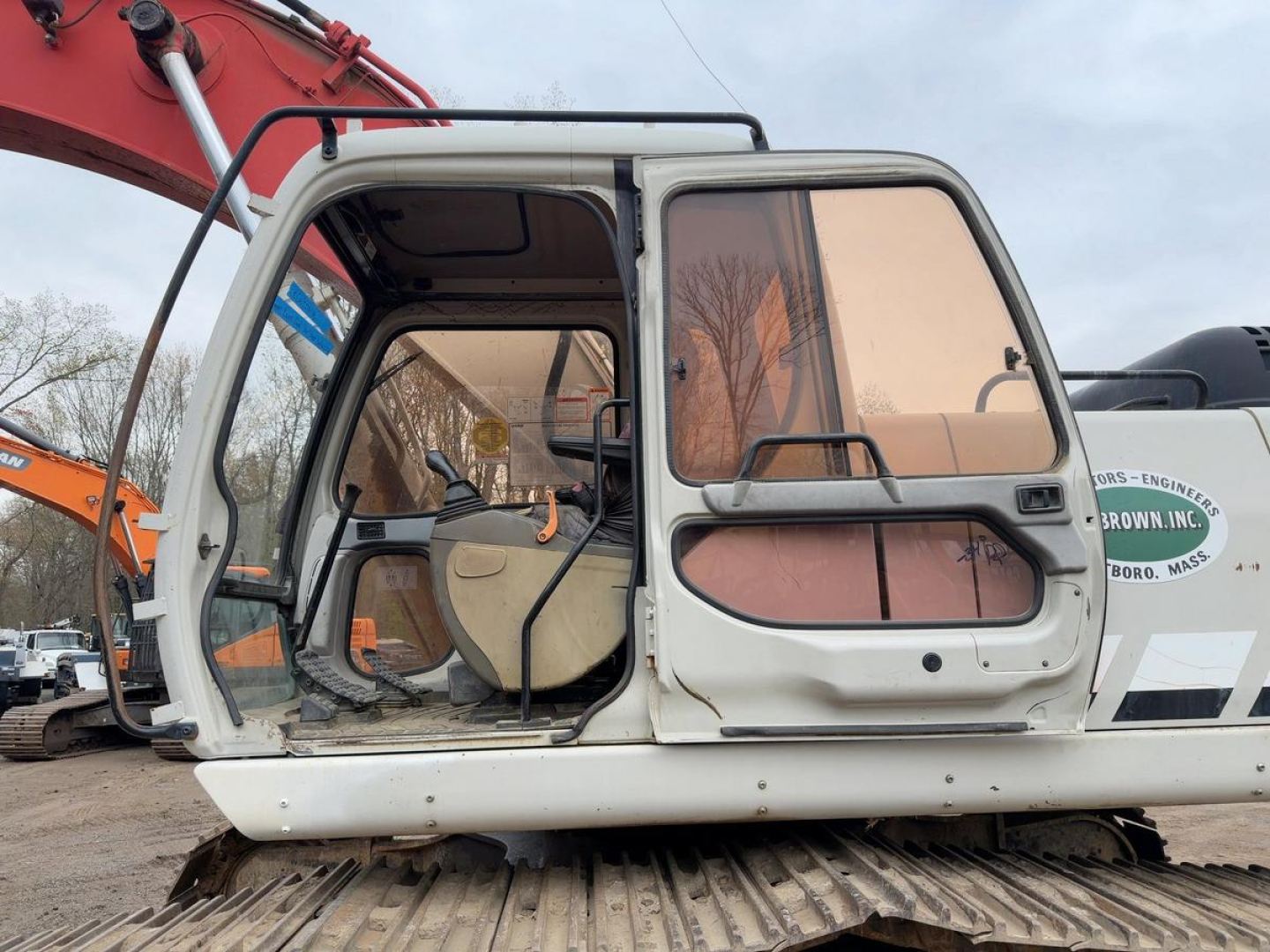 Excavator cabin of a 2007 Link Belt 330LX in-service showing open cab with seat, control levers, and operator seat; side window and operator door visible.