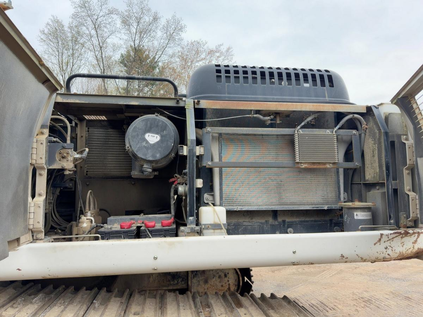 Link Belt 330LX excavator engine bay showing radiator, cooling fan, and hydraulic components with exposed engine bay; visible labels and components.