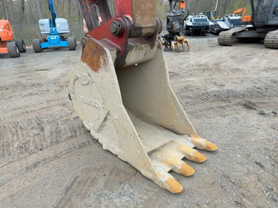 Buckets of a Link Belt 330LX excavator with yellow tips on the bucket teeth.