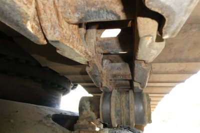 Crawler track undercarriage view of a 2007 Link Belt 330LX excavator showing rust and track links.