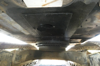 Underside view of a 2007 Link Belt 330LX excavator undercarriage and track drive, showing underframe and central mounting area.