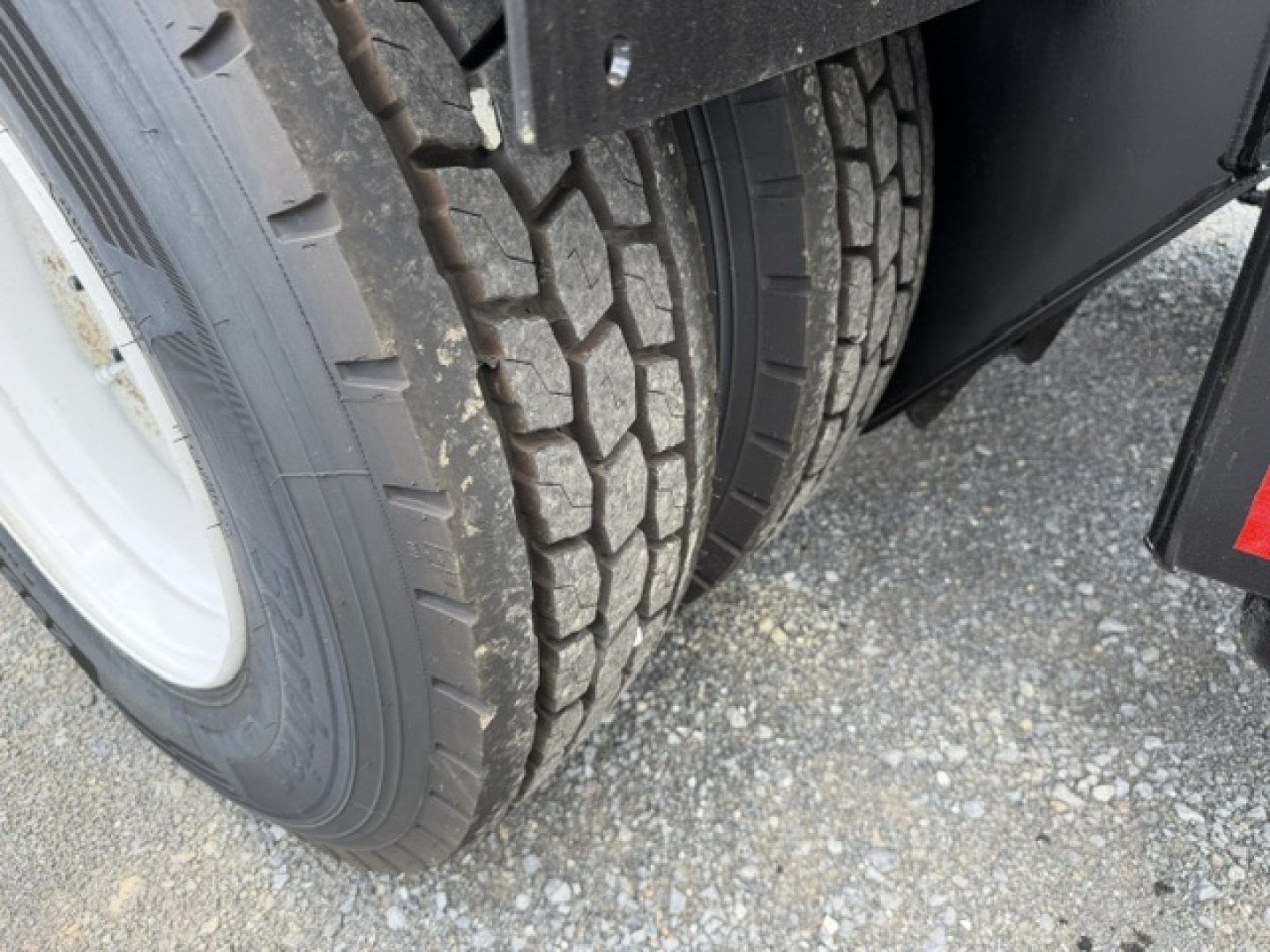 Truck dual rear wheels showing tire tread and wheel area of a 2018 Capacity Sabre DOT listing.