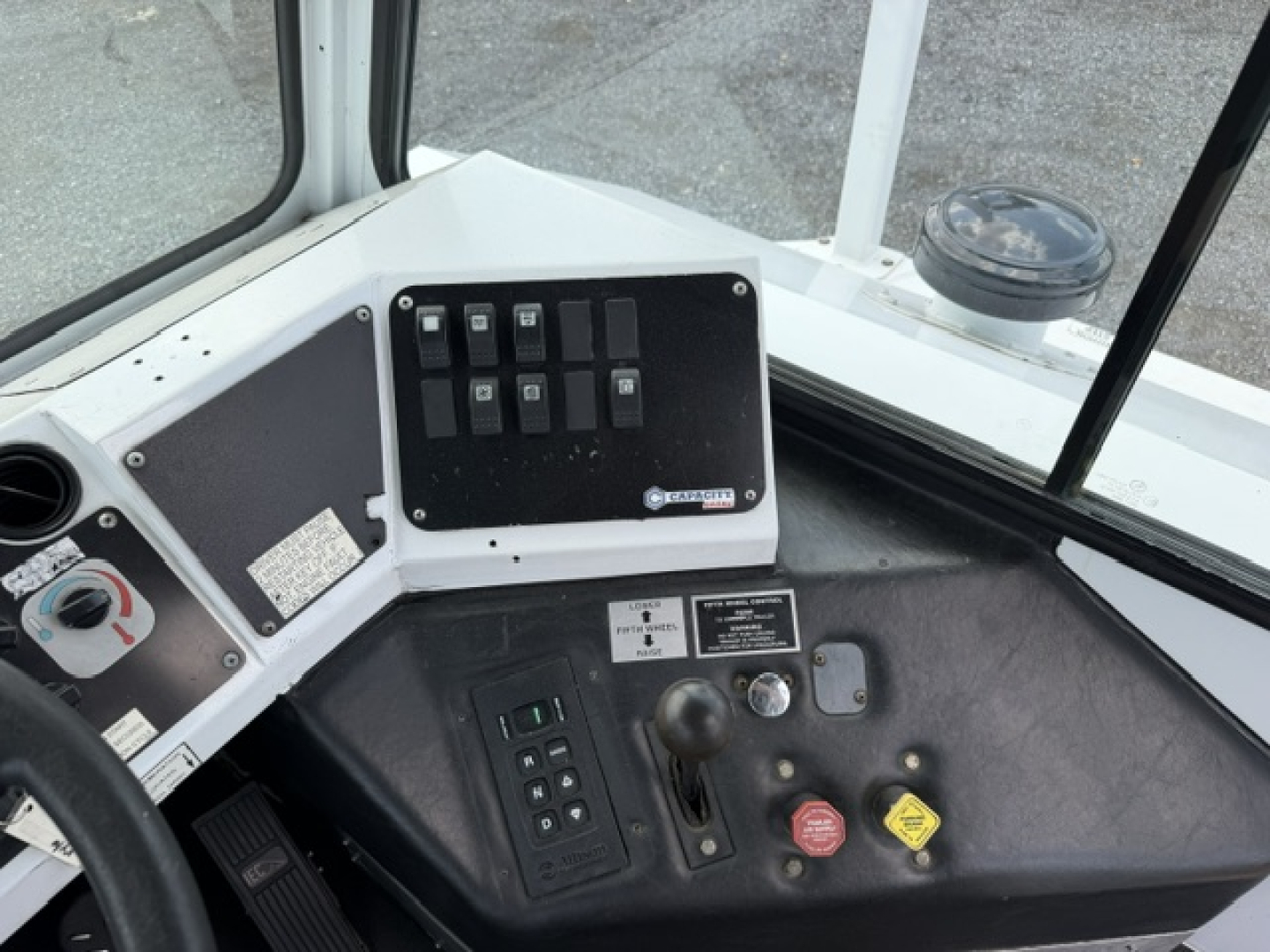 Dashboard panel with switches and gauges in a passenger bus cab showing control switches and knobs
