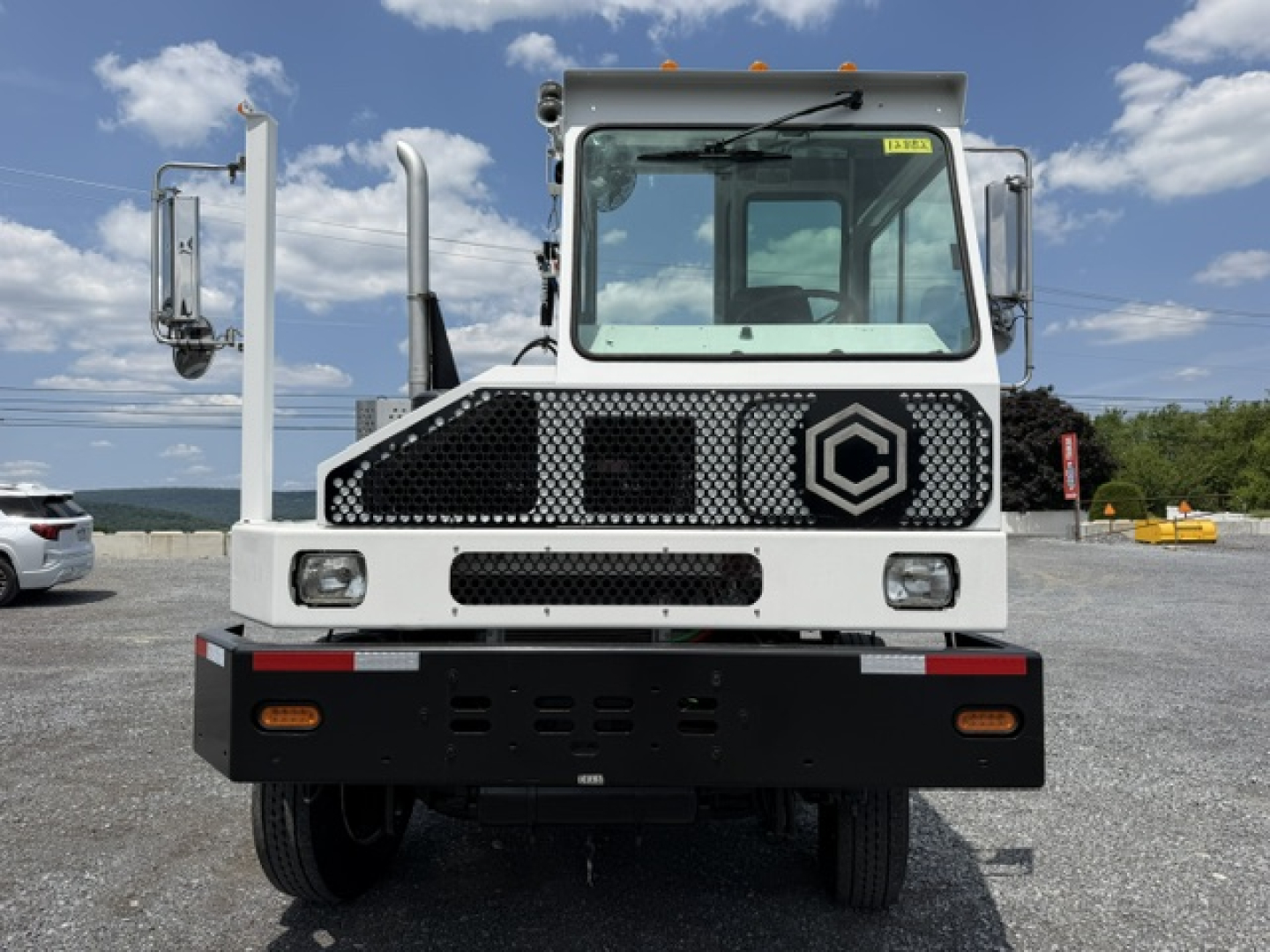 Cable-operated Capacity Sabre DOT yard truck front view showing grille, headlights, and cabin with large windshield and mirrors.