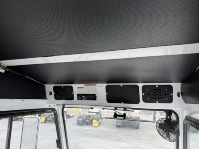Interior cab of a 2018 Capacity Sabre DOT truck showing overhead control panel with vents and a small fan mounted on the right.