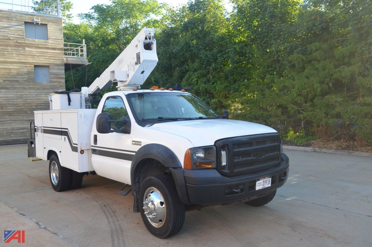Ford F-550 Super Duty boom truck front-left view showing bucket lift and utility body in white.