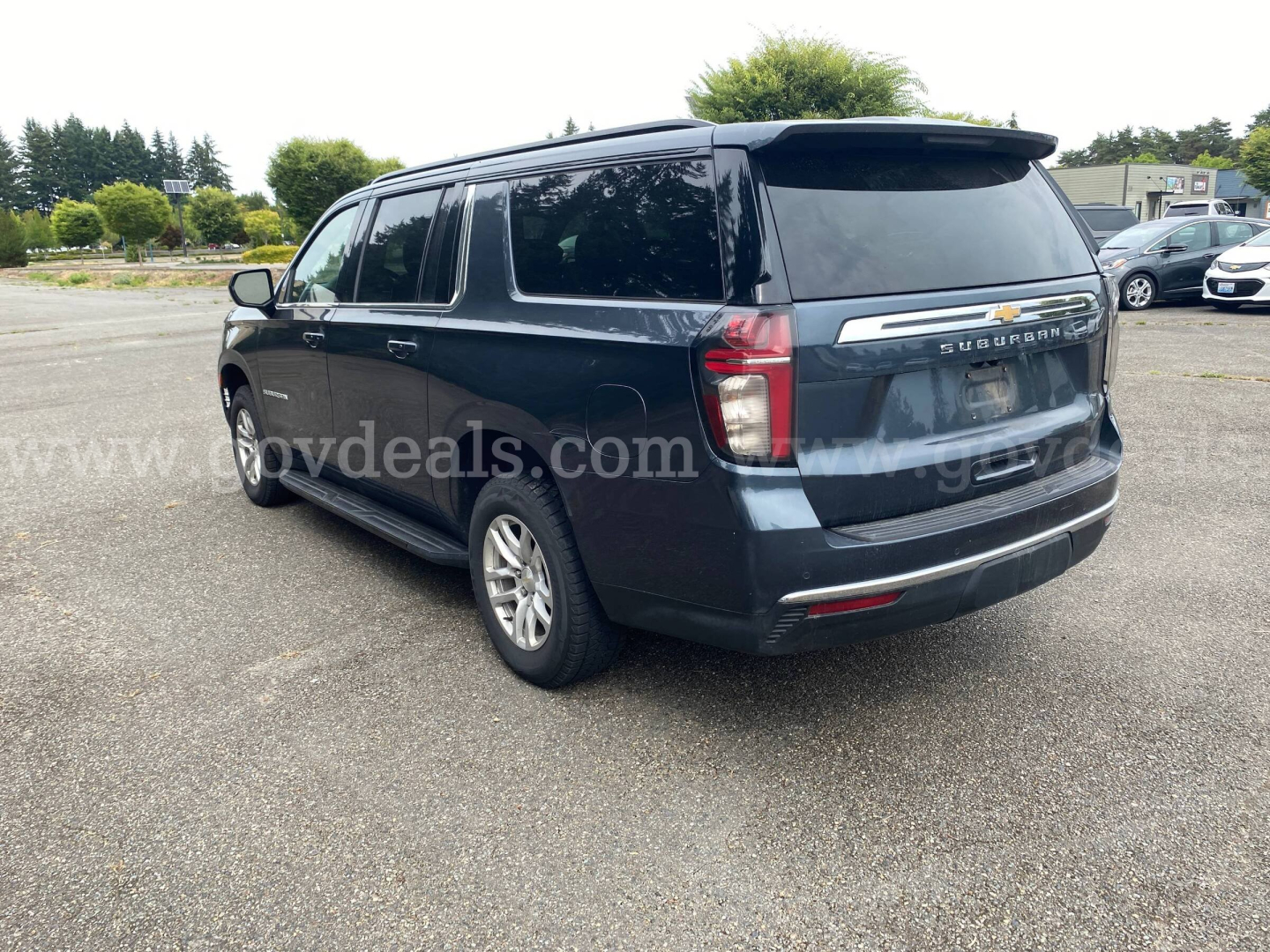 Chevrolet Suburban SUV rear-right view showing 4x door, taillights, and Suburban badge