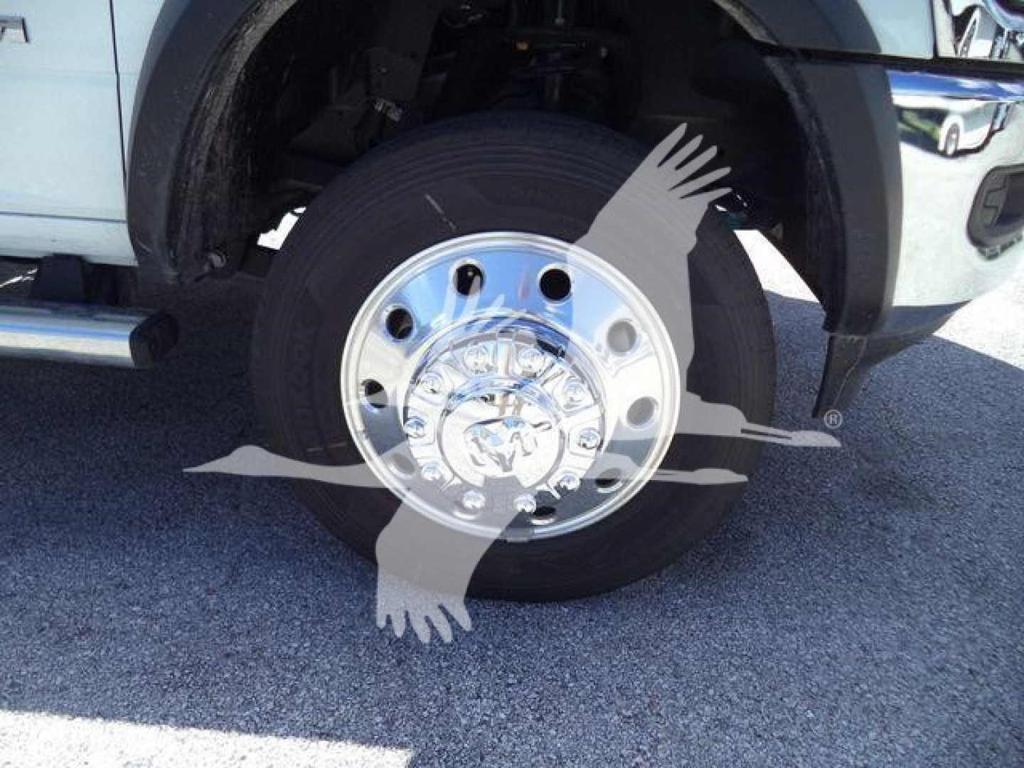 Truck front wheel and chrome rim, Ram 5500, partial fender, wheel well visible.