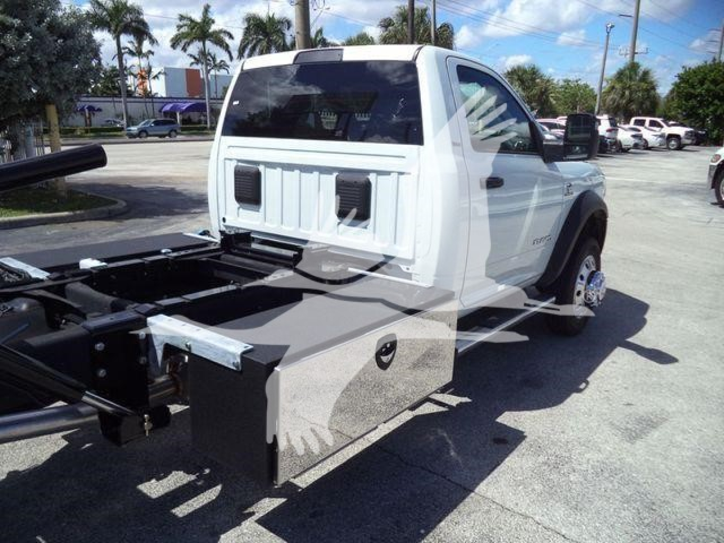 Ram 5500 rollback truck with utility box and chassis view showing rear of cab and mounting area.