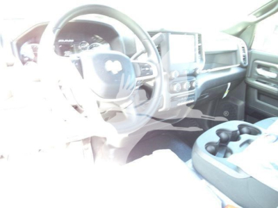 Ram 5500 cab interior showing steering wheel, dashboard, and center console; touchscreen display and cup holders visible