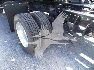 Ram 5500 rollback chassis showing dual rear wheels and drivetrain components with tires and suspension visible.