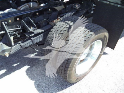 Dual rear wheel of a Ram 5500 rollback truck showing tire treads and chassis components.