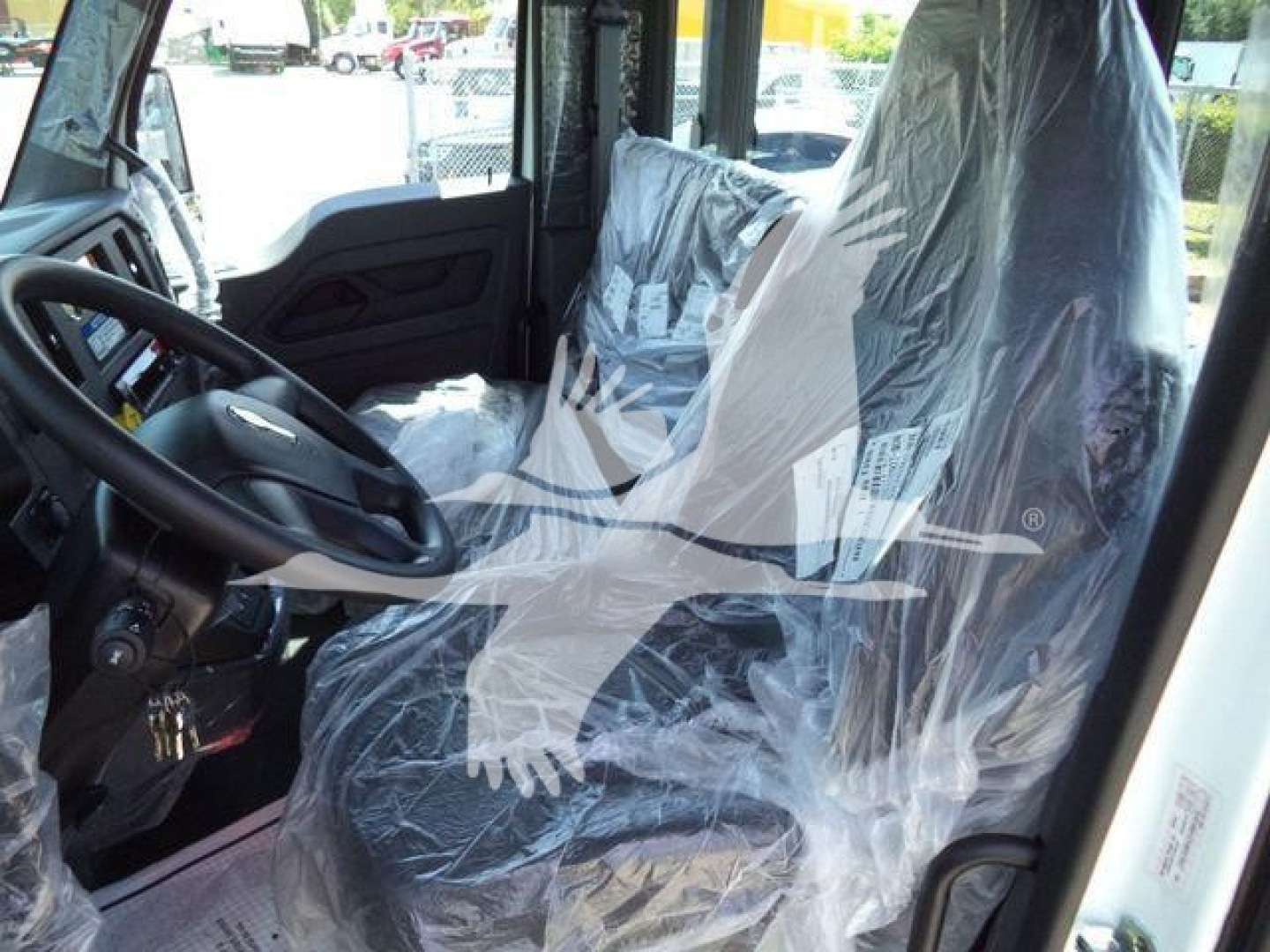 Kenworth T280 truck interior with plastic seat covers and steering wheel visible; new rollback truck listing.