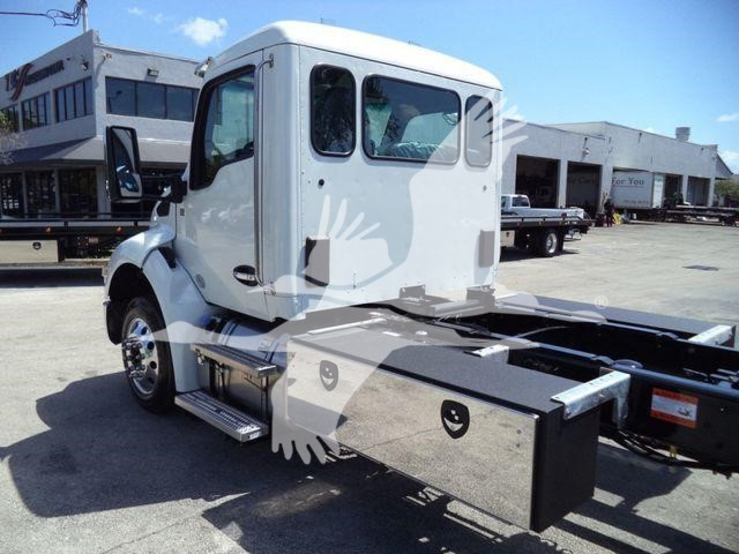 Kenworth T280 rollback truck cab side view showing storage toolbox mounted under cab and chassis frame