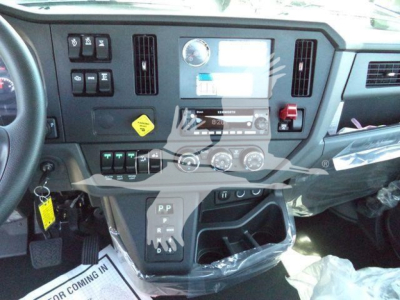 Dashboard area of a Kenworth T280 cab showing control panel, gauges, radio, climate controls, and gear selector.
