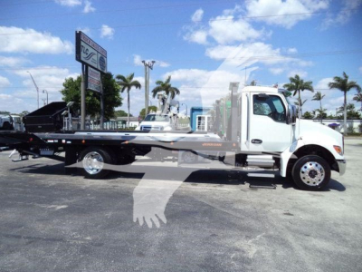 Kenworth T280 rollback truck in-side view showing flatbed car hauler with white cab and gray frame.