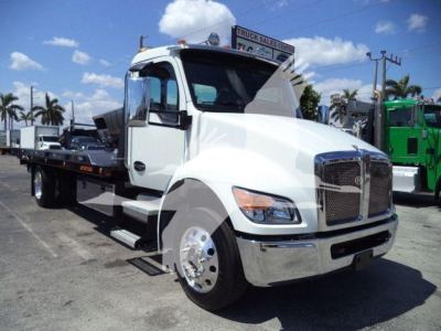Kenworth T280 rollback truck in white showing side view with front chrome grille and flatbed.