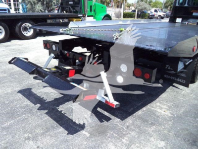 Kenworth T280 rollback truck rear view showing hydraulic tow arms and flatbed with stabilizers.