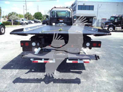 Kenworth T280 rollback tow truck bed rear view showing hydraulic deck and platform with warning lights and rear bumper.