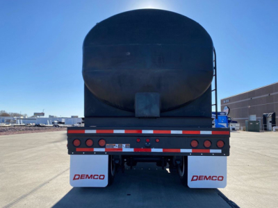 Demco Liquid Tender trailer back view showing rear bumper with red/white reflective tape and DEMCO mud flaps.