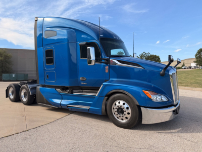 Kenworth T680 sleeper cab tractor in blue profile view showing front wheel, side steps, and fuel tanks.