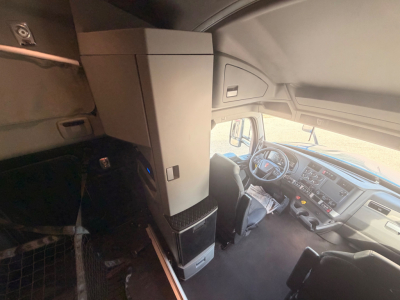 Kenworth T680 cab interior showing dashboard and driver seat with overhead storage and center console