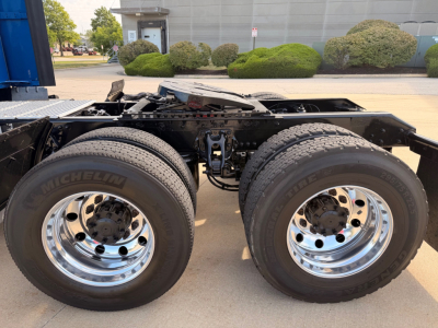 Kenworth T680 chassis showing dual rear axles with Michelin tires and chrome wheels, frame rails and fifth wheel area visible.