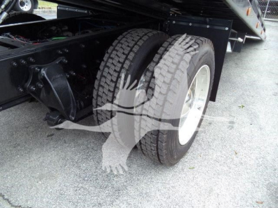 Freightliner M2 106 rollback truck rear dual wheels and undercarriage; visible tires and suspension components.