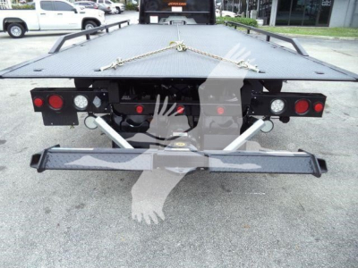 Freightliner M2 106 rollback bed rear view showing tail lights, bumper, and tie-down chains.