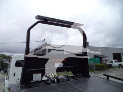 Freightliner M2 106 rollback truck bed with hydraulic lift and rear rack visible.