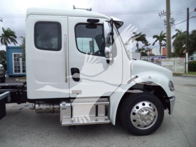 Truck cab side profile showing Freightliner M2 106 with white paint, single cab, chrome fuel tank, aluminum side steps, wheel, and side mirror.